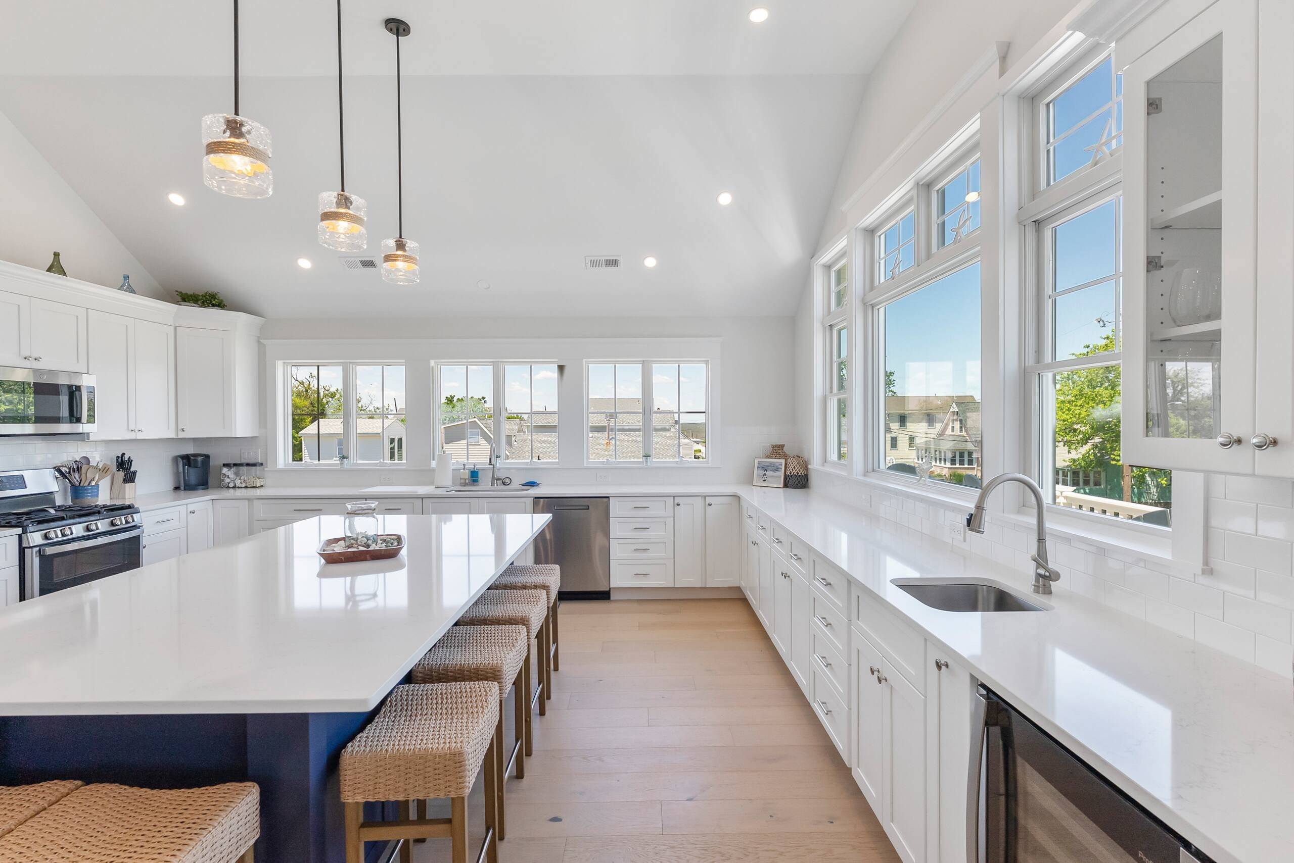 Kitchen at The Delford with a white island and windows