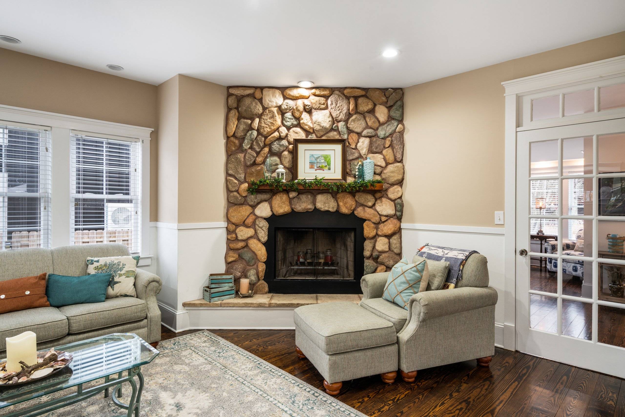 Main living room by the stone fireplace